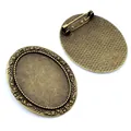 Detailed view of antique bronze oval brooch base with decorative floral edges and safety pin - Antique Bronze Floral Decorative Style (B2-13)