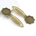 Macro shot of two vintage bronze star-edge bookmark trays for DIY jewelry making - Octagonal Star Edge Round Tray Style (J4-15)
