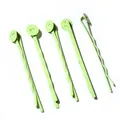 Detail view of five pale green matte snap hair clips with round flat pads on white background - Green