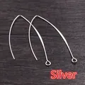 Detailed view of silver-plated V-shaped earring hooks on dark wood background - 28mm / Silver