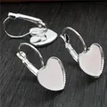 Silver 12mm heart lever-back earring hooks for DIY jewelry making on wood background - Silver