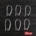 Detailed view of six silver DIY jewelry ear hooks with loops on dark wood background - Style 2 / Silver