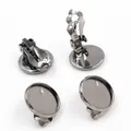 Macro view of gunmetal black DIY earring clips with round tray bases for jewelry making - Gunmetal