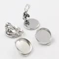 Macro detail of polished silver round tray clip-on earring bases for DIY jewelry making - 10mm / White K/Silver