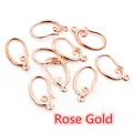 Macro shot of rose gold copper earring hooks with ornate scrollwork for DIY jewelry making - Rose Gold