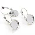 Close-up of three silver lever-back earring hooks with round bezel cups for DIY jewelry - White K/Silver