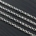Macro shot of silver plated iron O-chains for DIY jewelry making on dark wood background - Size 2.0 / Silver