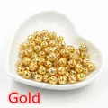 Macro detail of gold hollow filigree spacer beads for DIY jewelry making crafts - 6mm (100 Pieces/Pack/20g) / Gold