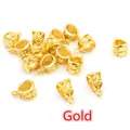 Detailed view of hollow carved gold alloy bail beads and pendant connectors for jewelry DIY - Gold