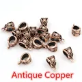 Macro shot of antique copper alloy pendant bails with retro floral engraving for jewelry DIY - Copper