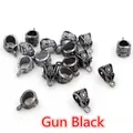 Detailed macro view of gun black alloy bails with vintage hollow patterns for DIY jewelry - Gunmetal