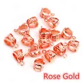 Macro detail of rose gold alloy bail connectors with hollow floral patterns for DIY jewelry - Rose Gold