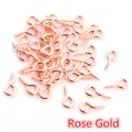 Macro shot of rose gold metal eye pin screws for DIY jewelry pendant connectors - Rose Gold