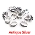 Close-up of antique silver alloy pendant bails with vintage baroque embossed patterns - Antique Silver