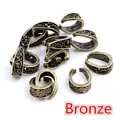 Detailed macro view of bronze alloy pendant bail connectors with vintage baroque texture - Antique Bronze