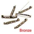 Macro view of bronze safety pins with 3 holes for DIY jewelry and brooch making - 15mm / Antique Bronze
