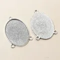 Zilveren ovale hangerbasis connectoren met vier gaten en geometrische achterkanttextuur - 30x40 / Antiek Zilver
