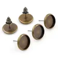 Macro detail of antique bronze earring studs with round blank tray bases for DIY jewelry - S / Bronze