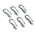 Macro view of six gunmetal black earring hooks with sparkling zircon stones and loops - Gunmetal