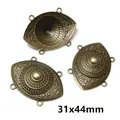 Macro view of 31x44mm antique bronze multi-hole connectors with embossed flower pattern - Oval Eye Style (AI1-02)