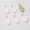 Detail view of pink enamel rugby ball charms showing front and textured alloy back - Pink