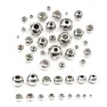 Detailed macro view of various sizes of polished stainless steel spacer beads for DIY jewelry - 2x1mm (100 Pieces/Pack) / Steel