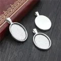 Macro view of three oval silver alloy pendant trays for DIY jewelry making - Silver Oval Bezel Tray (C2-02)