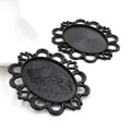Detail showing two black oval cabochon settings with hollow lace edges for DIY jewelry - Matte Black Oval Lace Style (B2-26)