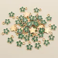 Close-up of DIY gold-plated flower charms with green enamel for jewelry making - Green Flower (E1-19)