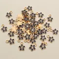 Macro shot of 11x9mm black drip oil flower charms with gold edges for DIY jewelry - Black Flower (E1-20)