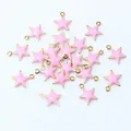 Macro detail of pink enamel star charms with gold-plated base for DIY jewelry making - Light Pink