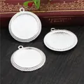 Three silver round 25mm pendant trays for DIY jewelry making on dark wood surface - Silver Style (C7-28)