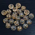 Macro detail of round resin cabochons with gold foil flakes on dark textured surface - Clear with Gold Foil Flakes