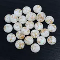 Macro detail of resin cabochons with gold foil and iridescent glitter on black wood - Milk White Gold Foil with Iridescent Flakes