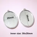 Detailed view of silver oval alloy pendant base with grid texture, inner size 38x28mm - C7-33 Oval Metal Pendant Tray (38x28mm)