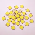 Close-up of mini yellow heart charms with gold metal edges and DIY hanging loops - Yellow