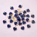 Macro shot of mini heart charms with deep blue enamel surface and gold textured back - Dark Blue