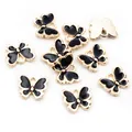 Vista detallada de colgantes de mariposa 10x13mm en oro con revestimiento de esmalte negro - Negro (AG7-04)