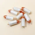 Eight resin pencil charms in white and orange marble finish with golden jump rings - White