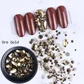 Flatback Ore Gold nail rhinestones in various shapes and sizes with nail art display - Black Round Bottle / Ore Gold
