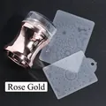 Macro view of rose gold nail stamper tool and two floral pattern stamping plates - Large Stamper And Plates / Rose Gold