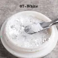 Macro detail of 07-White iridescent opal nail powder in a round container - White (07)
