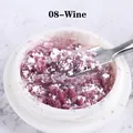 Macro shot of fine Wine Red 08 Opal nail glitter flakes in a jar with a small spatula - Wine (08)