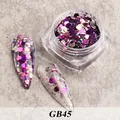 Detail of purple iridescent hexagonal nail sequins in mixed sizes on stone surface - Bottled Sequins Gb45
