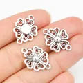 Three antique silver clover alloy pendants for DIY jewelry making on a hand - Antique Silver