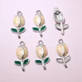 Detailed macro view showing six tulip bud pendants with silver frames and enamel finish - Cream Champagne