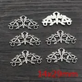 Macro detail of 14x29mm vintage silver leaf scroll alloy pendants and connectors - Leaf Scroll Style (P7-33)