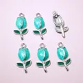 Macro shot of tulip charms with blue marble enamel and silver edges for jewelry making - Cyan Blue