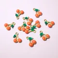 Macro detail of cherry-shaped gold-plated charms with colorful enamel for DIY jewelry making - Orange Red Cherry Style (E6-66)