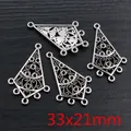 Macro view of four vintage silver alloy triangle charms with scrollwork for jewelry DIY - Vintage Scroll Triangle Style (AG2-24)